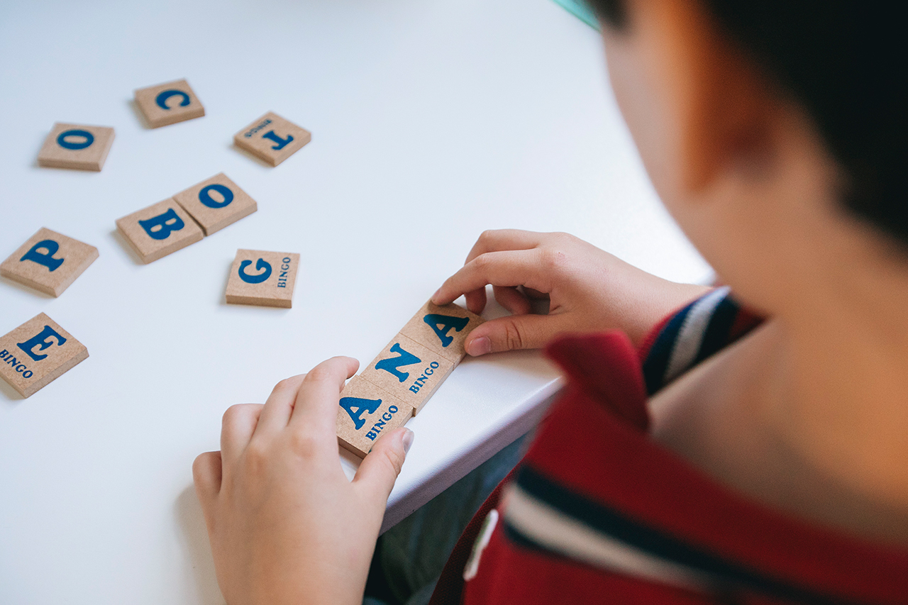 Aluno brincando com letras m&oacute;veis.