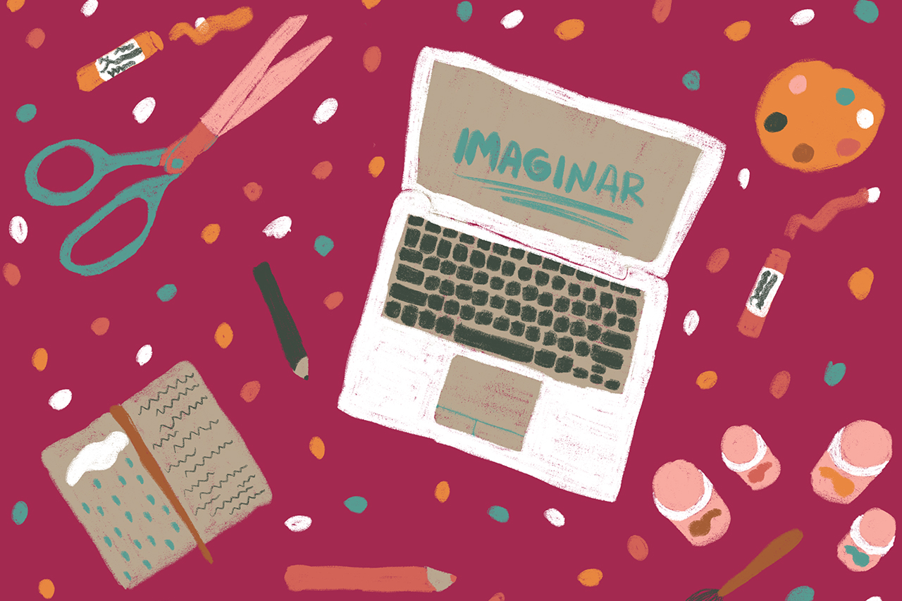 Notebook, com a palavra Imaginar escrita na tela, sobre mesa com objetos de desenho e recorte.